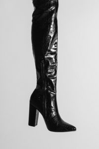A long, high-heeled, black leather boot