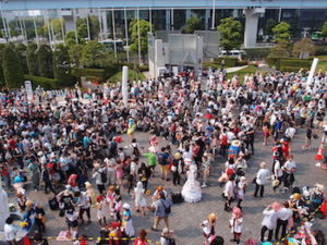 An outdoor crowd at a comic and fan convention.