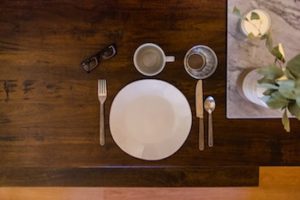 Carefully placed dining set on a wooden table.