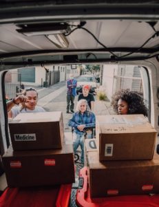 The back of the van being loaded by volunteers with medicine and supplies.