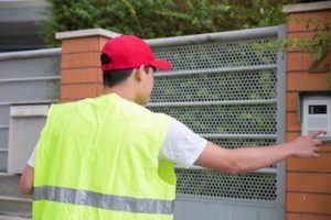 Mail man delivers mail while wearing a construction vest