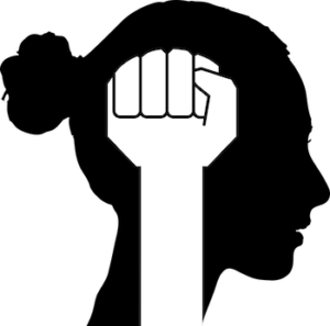 Black and white silhouette of woman's head with freedom fist 