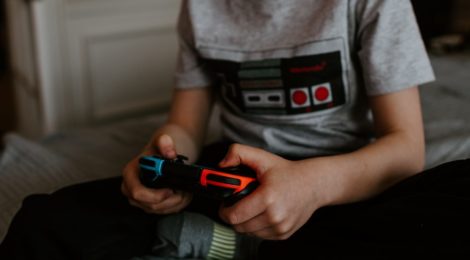 kid sitting while playing Nintendo switch