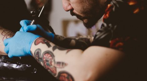 Tattoo artist tattooing a client